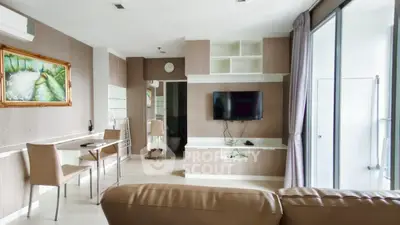 Modern living room with stylish decor and wall-mounted TV, featuring a cozy dining area and large windows for natural light.