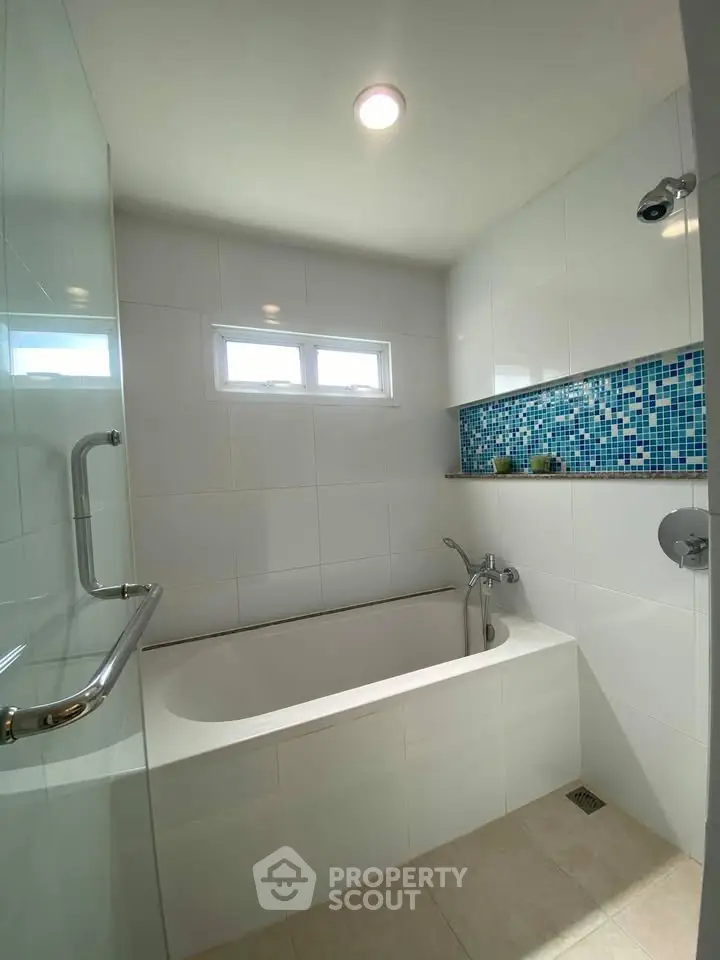 Modern bathroom with elegant bathtub and stylish tile accents