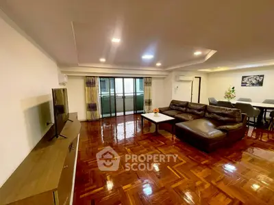 Spacious living room with elegant wooden flooring and modern furniture