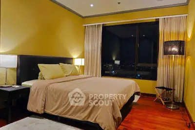 Luxurious bedroom with city view, elegant lighting, and cozy ambiance.