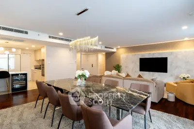 Luxurious open-plan living and dining area with elegant marble table and modern decor