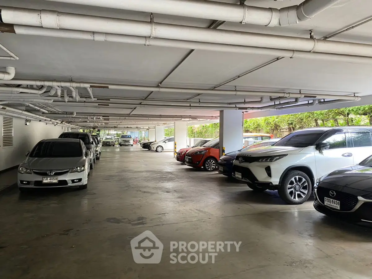 Spacious indoor parking area with multiple cars parked, showcasing ample space and modern design.