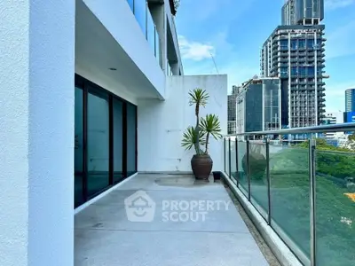Spacious balcony with city view in modern high-rise building, perfect for urban living.