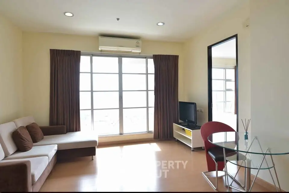 Bright and airy living room with modern furniture and large windows in a stylish apartment.