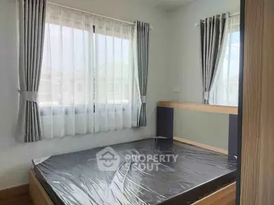 Bright bedroom with large windows and modern decor