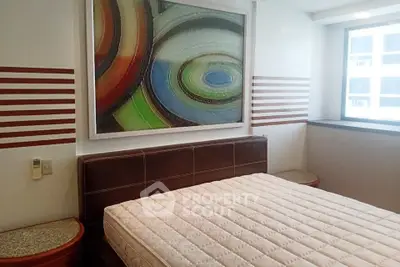 Modern bedroom with abstract art and natural light in urban apartment