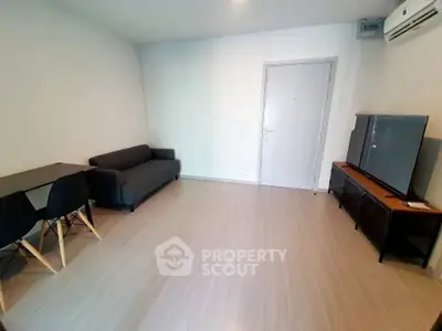 Modern living room with sleek furniture and minimalist design, featuring a comfortable sofa and dining area.