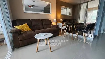 Modern living room with cozy brown sofa, stylish mirrors, and elegant decor.