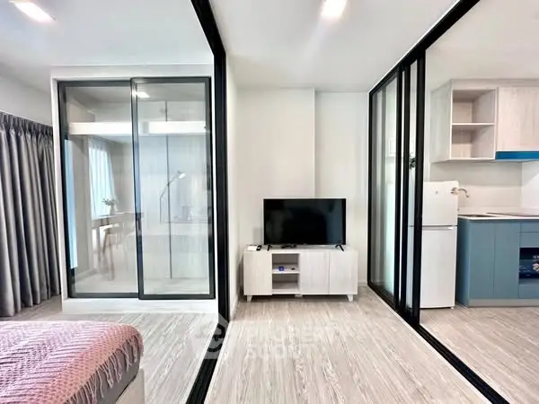 Modern open-plan apartment with glass partitions and sleek furnishings