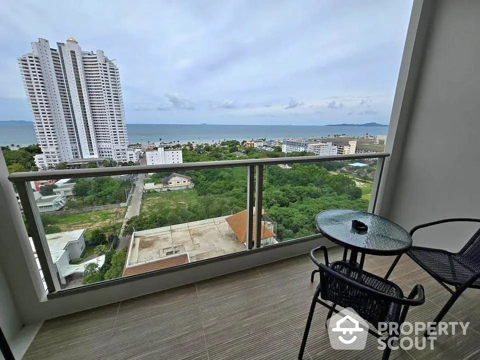 Stunning balcony view of the ocean and cityscape with modern high-rise buildings in the distance.