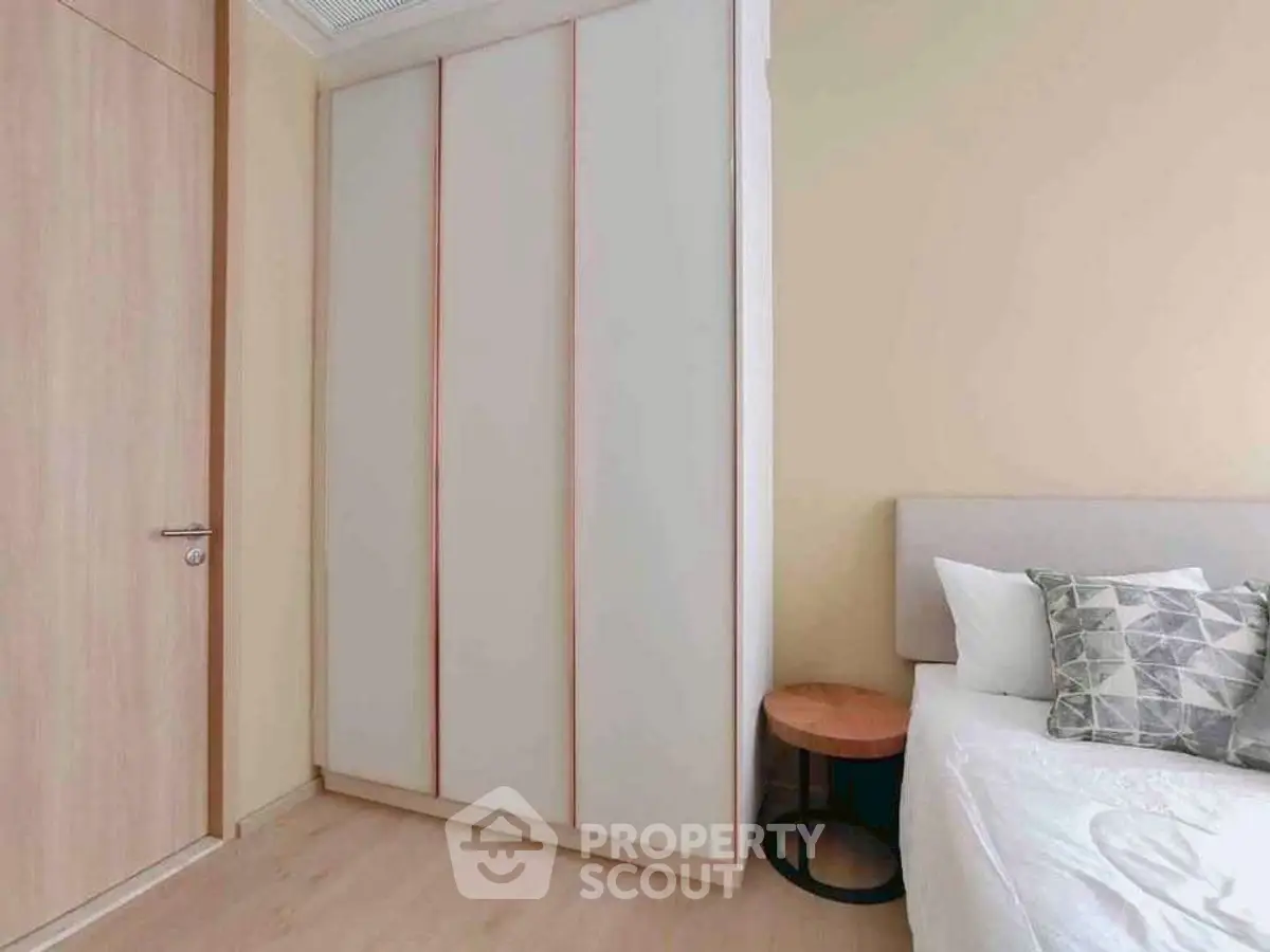 Modern bedroom with sleek wardrobe and cozy bed setup