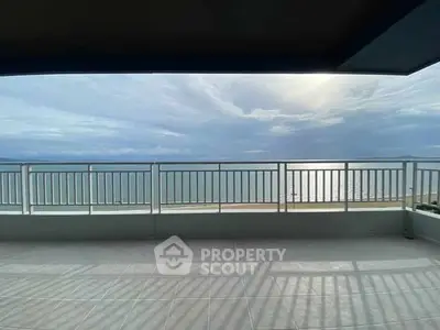 Stunning ocean view from spacious balcony with modern railing.