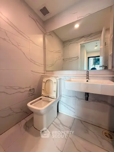 Modern bathroom with sleek marble tiles and contemporary fixtures