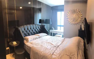 Luxurious bedroom with elegant decor and large window offering natural light