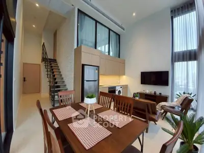 Modern loft-style living room with high ceilings and stylish decor