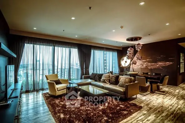 Luxurious living room with city view, elegant decor, and plush seating