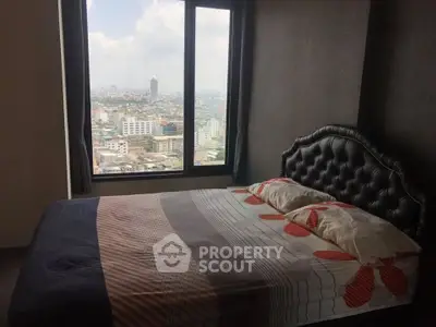 Cozy bedroom with stunning city view from large window, featuring elegant headboard and modern bedding.