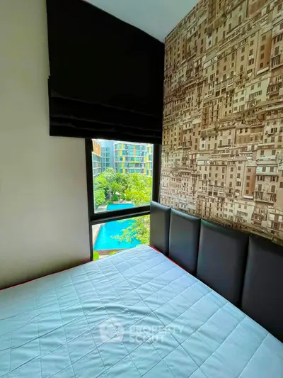Cozy bedroom with cityscape wallpaper and pool view, perfect for urban living.