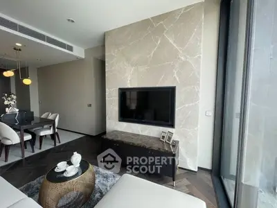 Luxurious modern living room with elegant dining area and large TV, featuring marble accents and floor-to-ceiling windows.