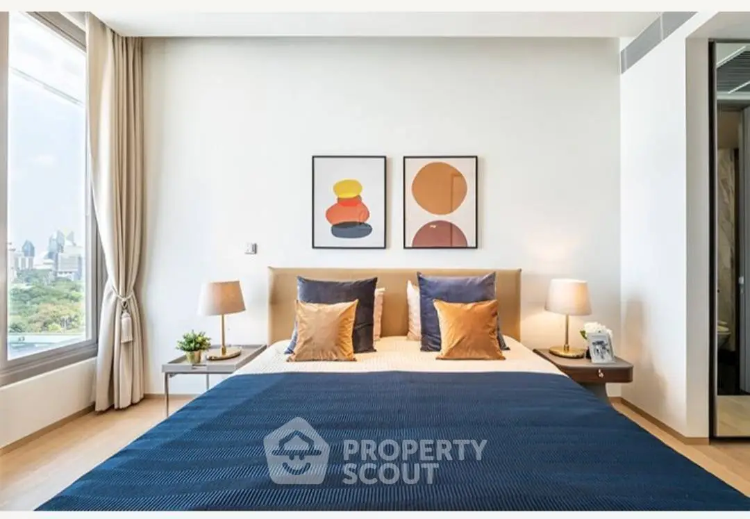 Modern bedroom with stylish decor and city view, featuring a cozy bed and elegant lighting.