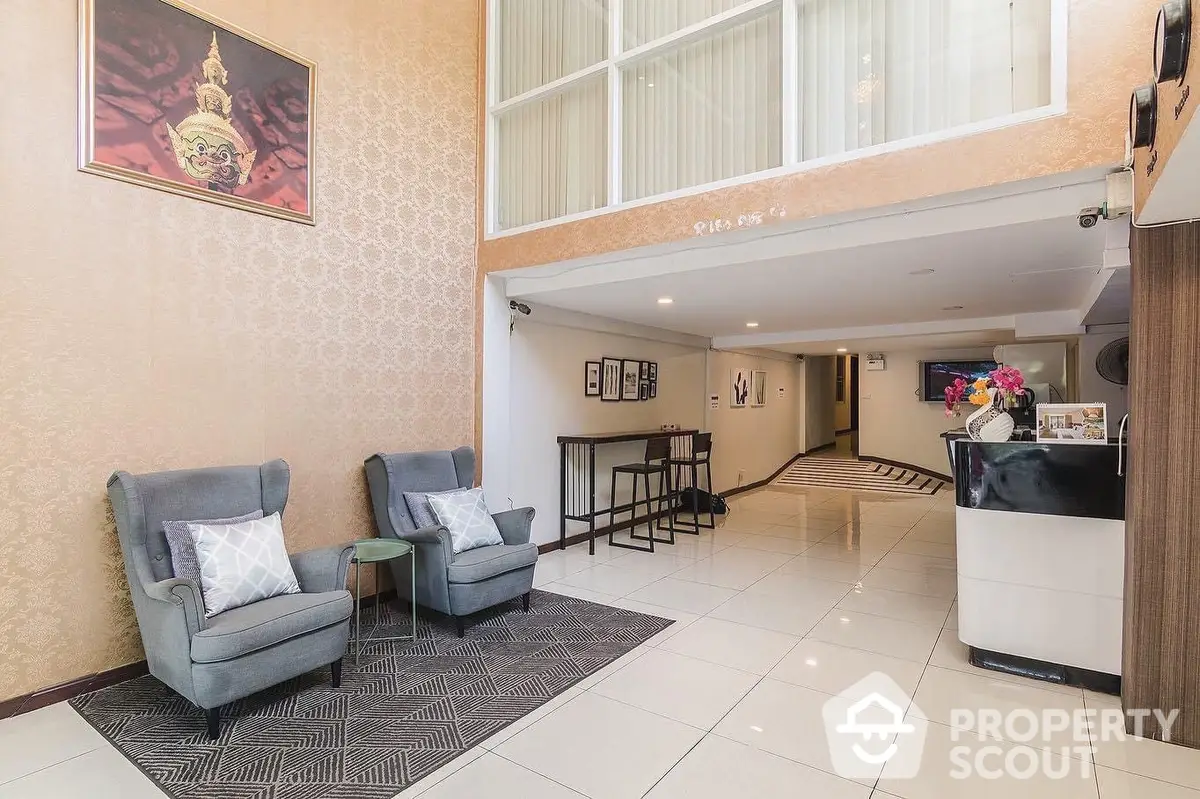 Spacious and welcoming lobby area with comfortable seating, elegant decor, and a well-lit interior, perfect for high-end residential or commercial buildings.