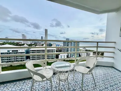 Stunning balcony with ocean view and elegant tile flooring in a high-rise apartment.