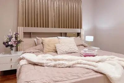 Cozy bedroom with plush bedding and elegant decor, perfect for relaxation.