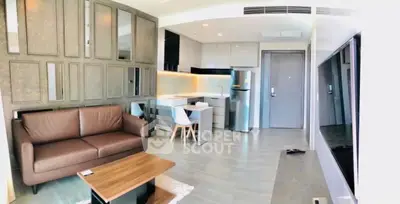 Modern open-layout living room with sleek kitchen and stylish furniture