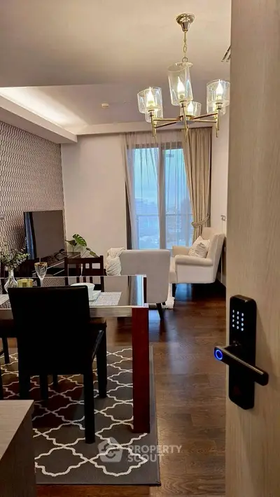 Elegant living room with modern decor and city view, featuring stylish lighting and cozy seating.