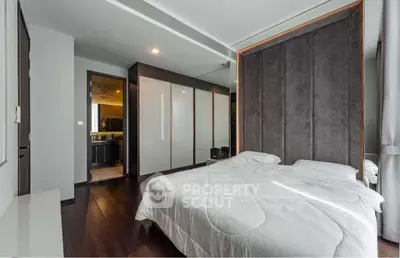 Modern bedroom with sleek design and dark wood flooring
