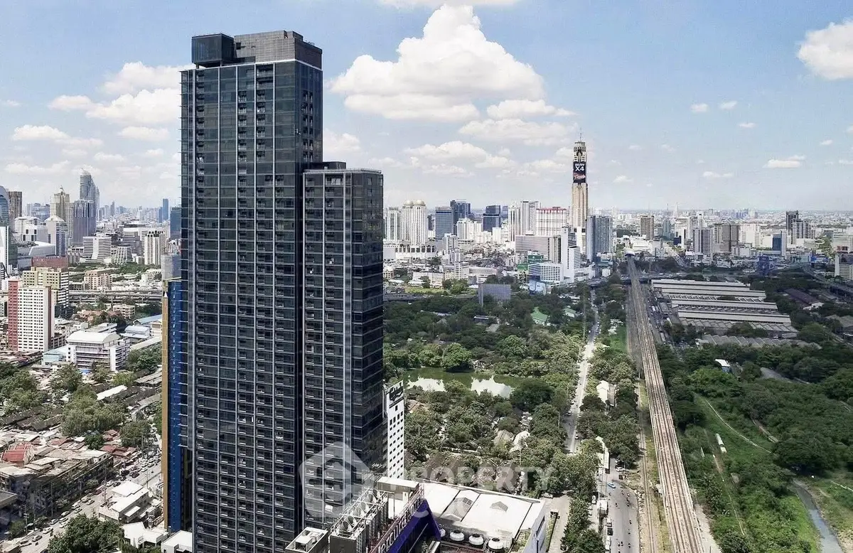 Stunning high-rise building with panoramic city views and lush green surroundings.
