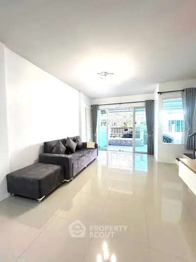 Spacious living room with modern sofa and large windows for natural light