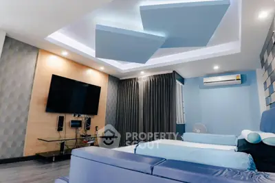 Modern living room with stylish ceiling design and large TV setup