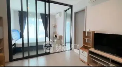 Modern bedroom with sliding glass doors and natural light