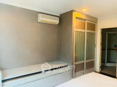 Modern bedroom with built-in storage and air conditioning unit