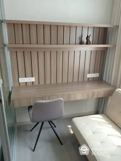 Modern study nook with wooden desk and shelves, perfect for home office setup.