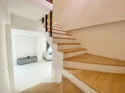 Modern interior with wooden staircase and bright living area