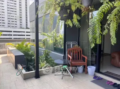 Charming balcony with lush greenery and cozy seating in urban setting