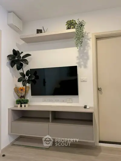 Modern living room with wall-mounted TV and stylish shelving unit