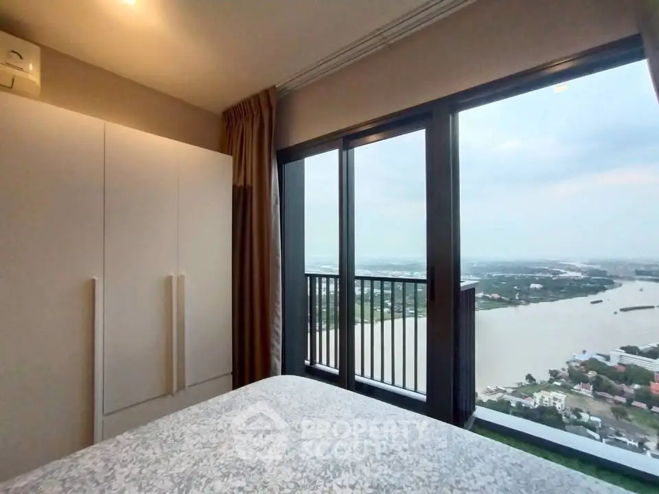 Stunning bedroom with floor-to-ceiling windows offering breathtaking river views.