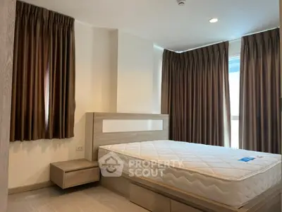 Modern bedroom with large windows and elegant curtains in a stylish apartment.