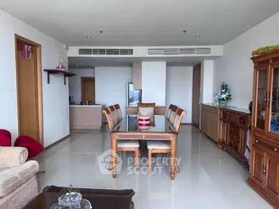 Spacious living room with elegant dining area and modern furnishings in a luxurious apartment.