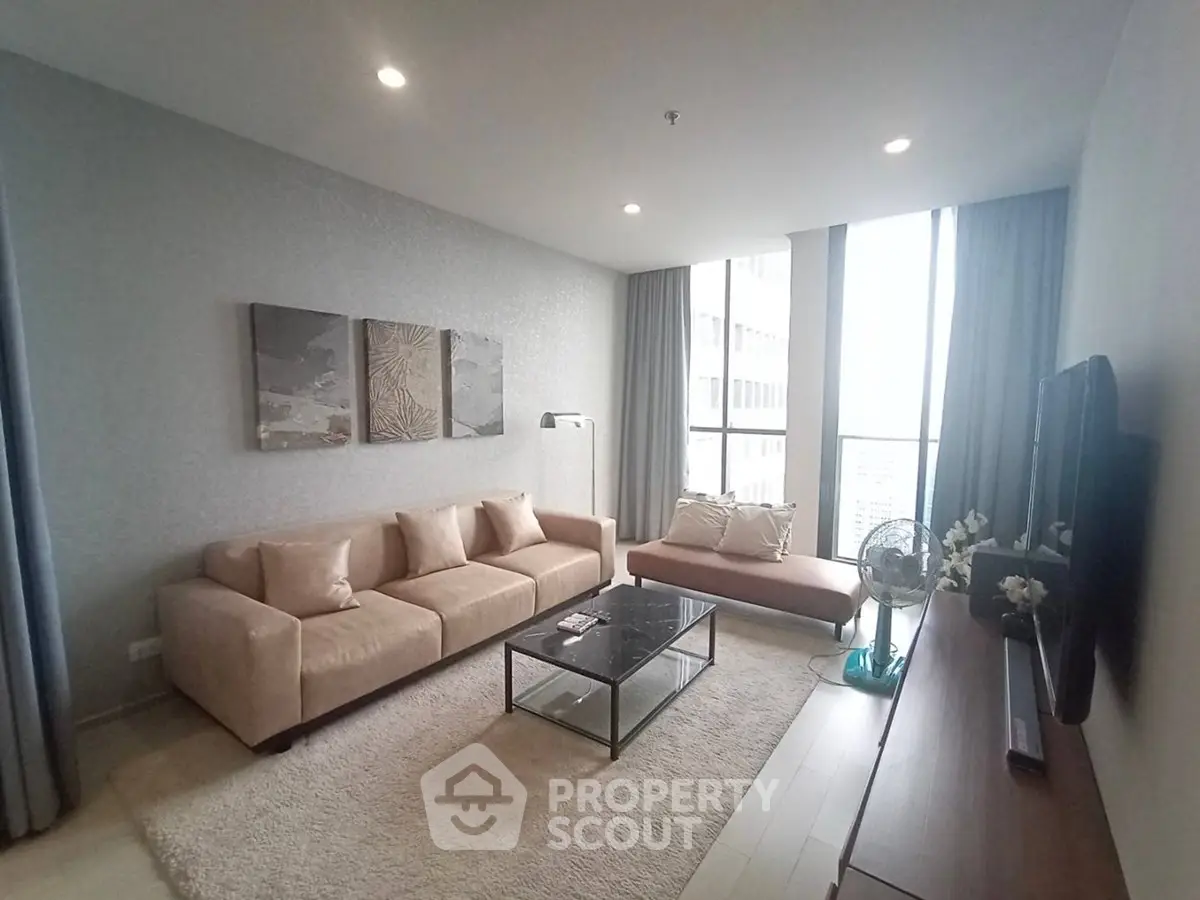 Spacious modern living room with large windows and elegant decor