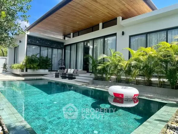 Luxurious modern villa with private pool and lush greenery, perfect for relaxation and entertainment.