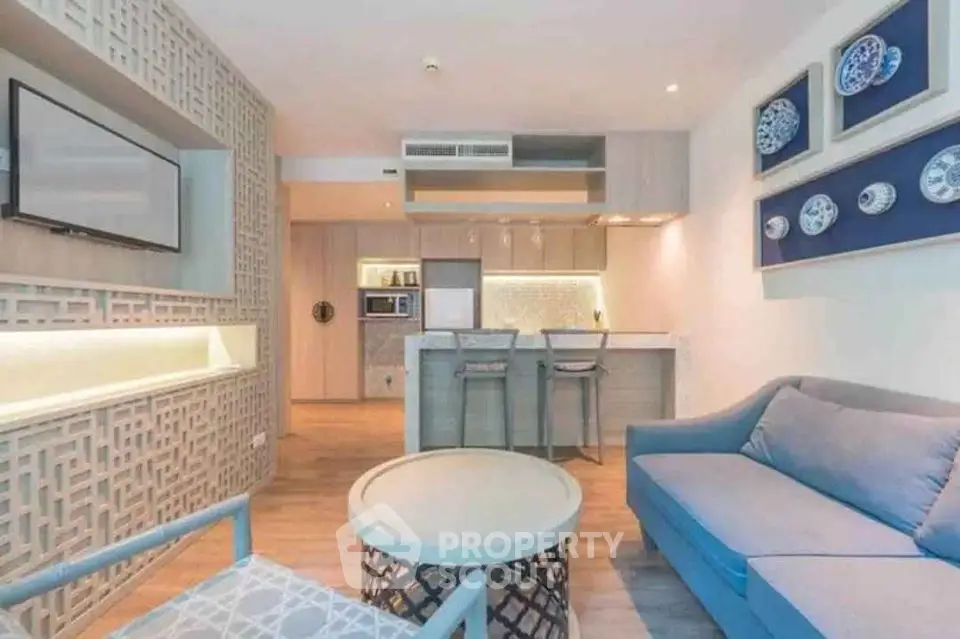 Modern living room with stylish decor and open kitchen layout in a cozy apartment.