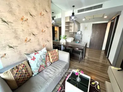 Stylish modern living room with open kitchen and vibrant decor in a cozy apartment.