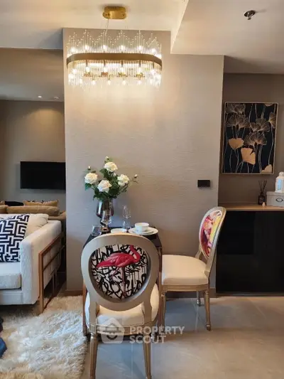 Luxurious living room with elegant chandelier and stylish dining area