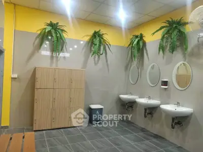 Modern shared bathroom with lockers and stylish decor