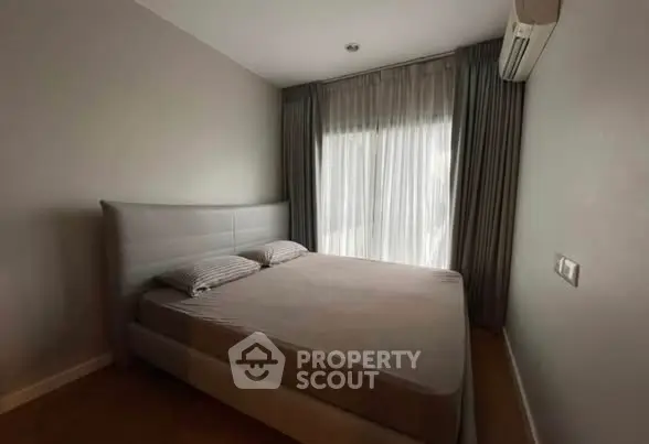 Cozy bedroom with natural light and modern air conditioning unit.