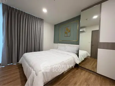 Modern bedroom with stylish decor and large mirror wardrobe